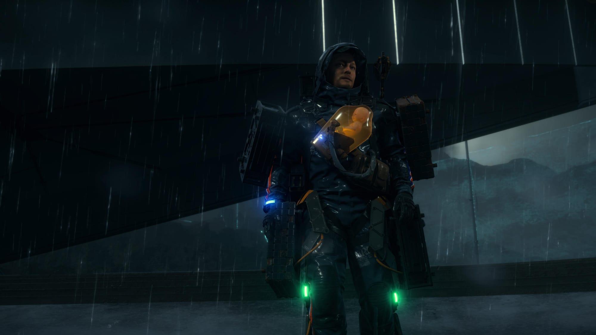 Screenshot of Death Stranding, featuring the main character, Sam, in the rain.